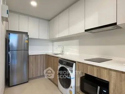 Modern kitchen with sleek appliances and ample storage space