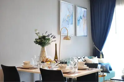 Elegant dining area with modern decor and natural light in a stylish apartment.
