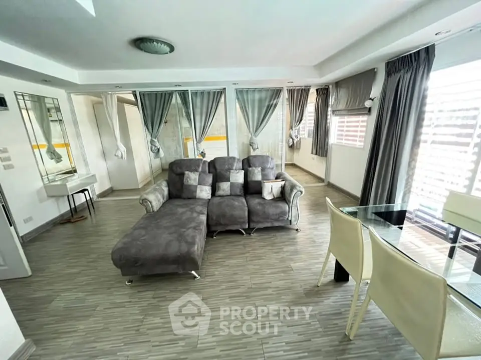 Spacious modern living room with stylish decor and ample natural light