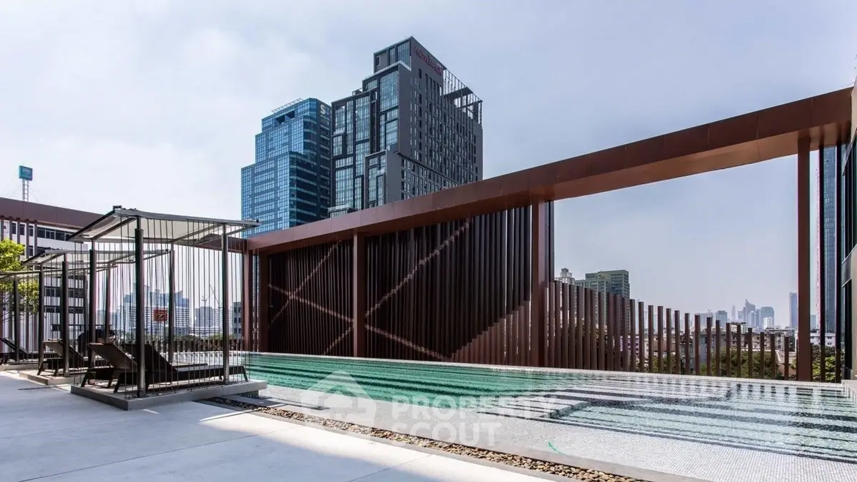 Luxurious rooftop pool with stunning city skyline views in modern high-rise building.