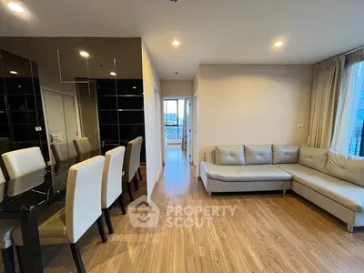Modern living room with sleek furniture and wooden flooring in a stylish apartment.