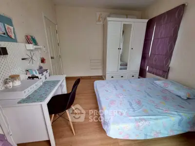 Charming bedroom with cozy decor and ample storage in a modern real estate listing.
