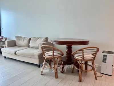 Chic living room with cozy sofa and elegant wooden dining set