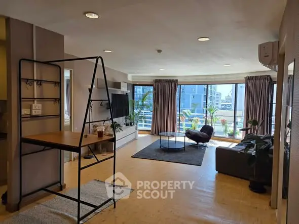 Spacious modern living room with large windows and stylish decor