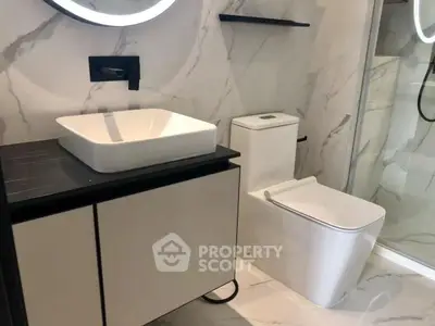 Modern bathroom with sleek fixtures and marble walls