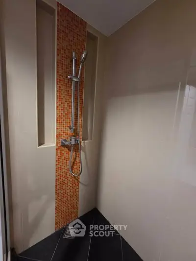 Modern bathroom with sleek shower design and stylish tile accents
