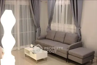 Elegant living room with modern gray sofa and stylish decor