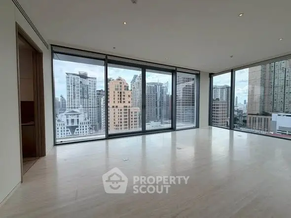 Spacious corner unit with floor-to-ceiling windows offering stunning city views in a modern high-rise.