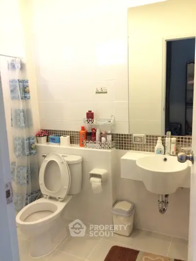Modern bathroom with sleek fixtures and stylish tile accents, perfect for a contemporary home.