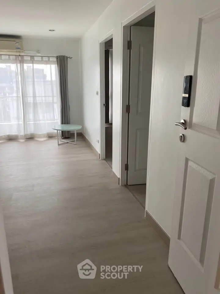 Spacious apartment hallway with natural light and modern design