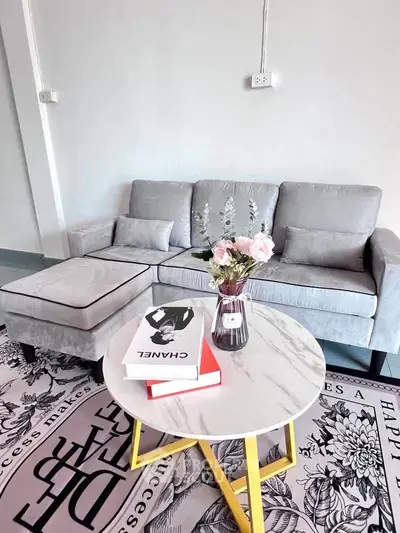Stylish living room with modern gray sofa, chic coffee table, and elegant decor accents.