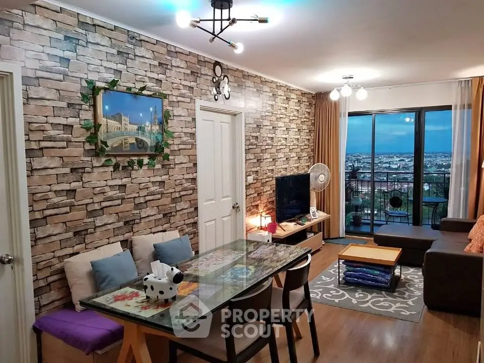 Stylish living room with brick accent wall and city view balcony, perfect for modern urban living.