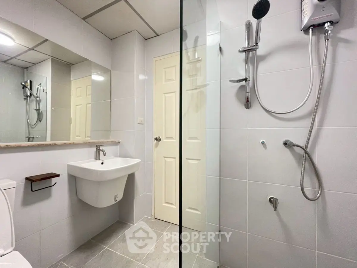 Modern bathroom with sleek fixtures and spacious shower area.