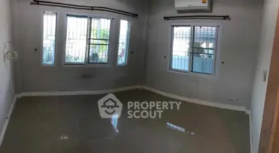 Spacious unfurnished room with large windows and air conditioning unit.