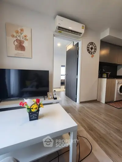 Modern living room with stylish decor and open kitchen layout, featuring a cozy ambiance and contemporary design.