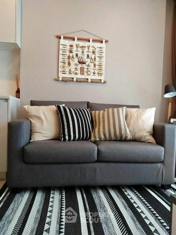 Modern living room with stylish gray sofa and decorative wall art