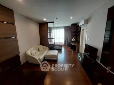 Modern living room with wooden flooring and stylish furniture in a cozy apartment.