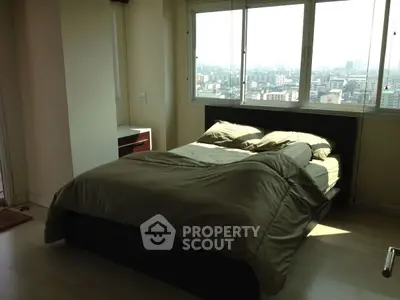 Spacious bedroom with city view and natural light
