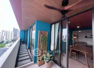Stylish balcony with city view, wooden ceiling, and modern interior access