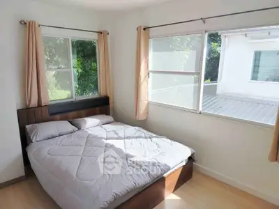 Bright bedroom with large windows and cozy bed in modern home