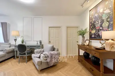 Elegant living room with stylish decor, featuring cozy seating and a chic desk area, perfect for modern living.