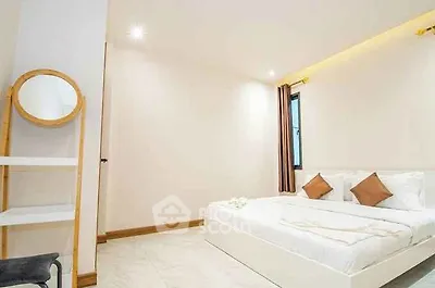 Modern minimalist bedroom with cozy lighting and stylish decor.