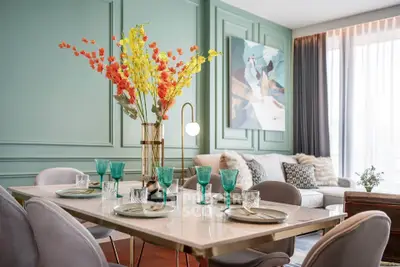 Elegant dining area with modern decor and vibrant floral centerpiece