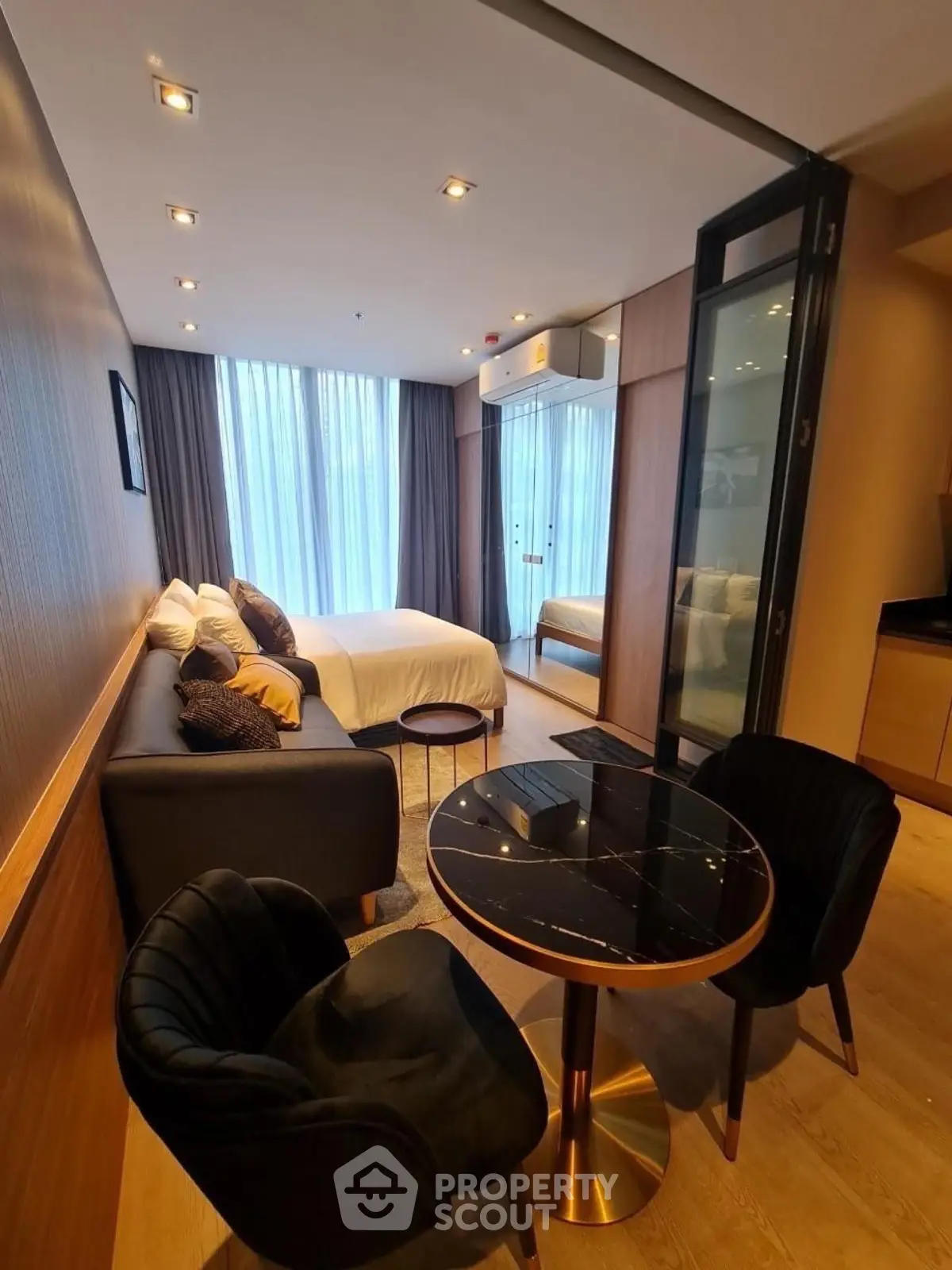 Modern studio apartment with cozy living area and stylish bedroom