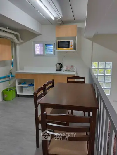 Compact kitchen with dining table and modern appliances in cozy apartment