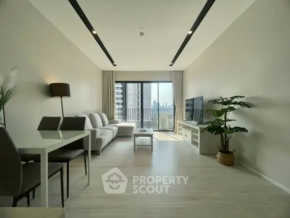 Spacious modern living room with large windows and city view, perfect for urban living.