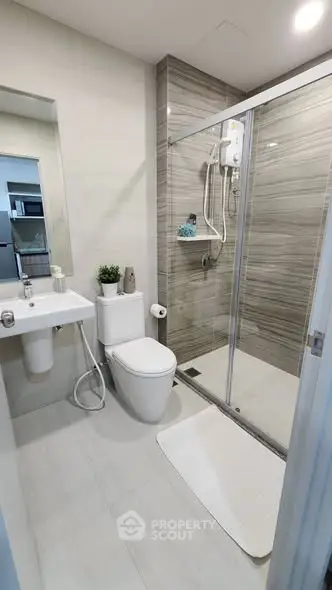 Modern bathroom with sleek shower and elegant fixtures in a contemporary apartment.