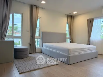 Spacious bedroom with large windows and modern decor