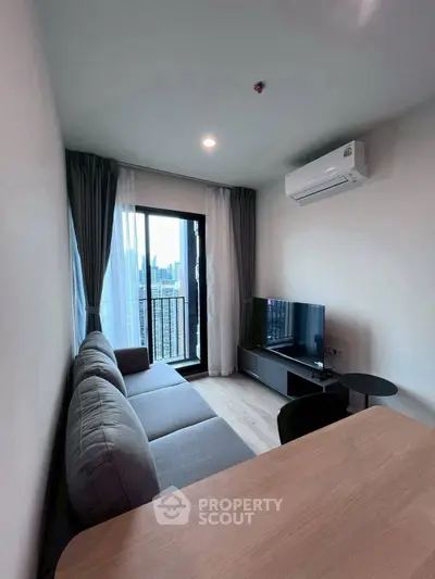 Modern living room with balcony view in high-rise apartment