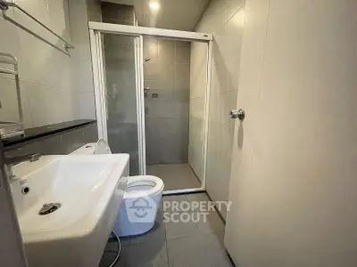Modern bathroom with sleek shower and contemporary fixtures in a stylish apartment.