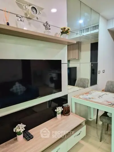 Modern living room with sleek TV setup and stylish dining area