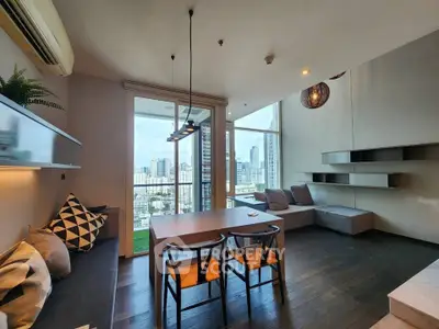 Modern living room with city view, stylish furniture, and open layout in high-rise apartment.