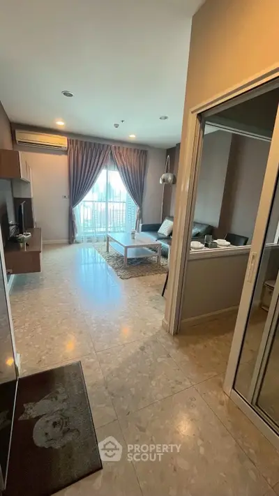 Spacious modern living room with elegant decor and large windows for natural light.