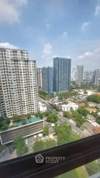 Stunning cityscape view from high-rise apartment window showcasing modern urban living.