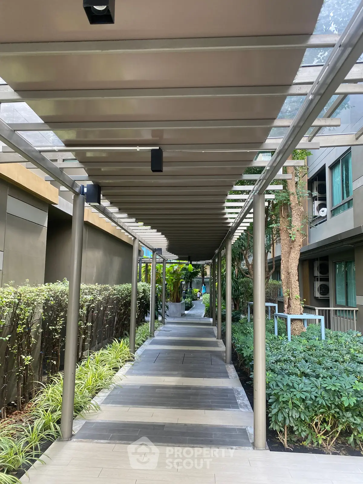 Modern building entrance with landscaped walkway and sleek design