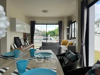 Modern living room with stylish decor and large windows offering natural light.