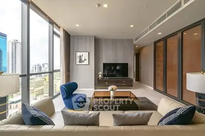 Luxurious modern living room with panoramic city views and elegant furnishings.