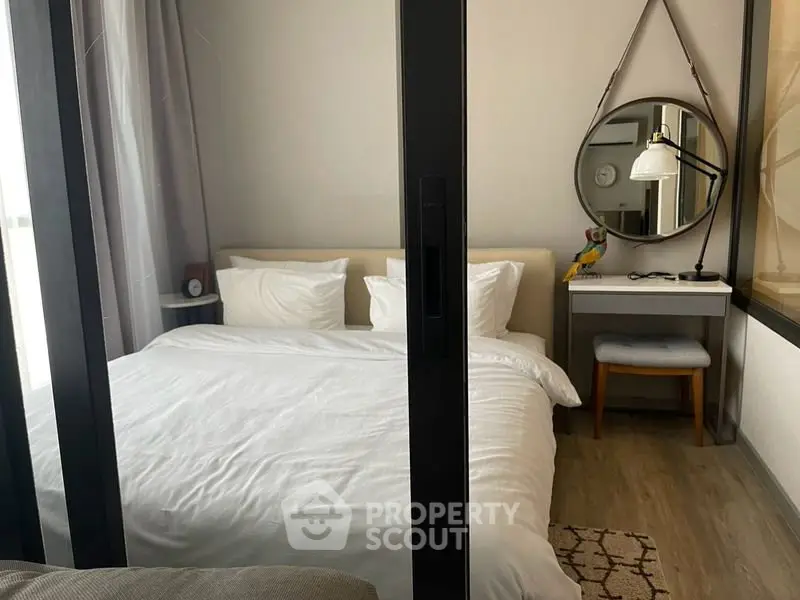 Cozy bedroom with modern decor and stylish mirror