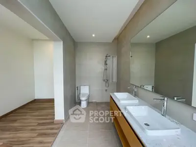 Spacious modern bathroom with dual sinks and elegant fixtures in a contemporary home.