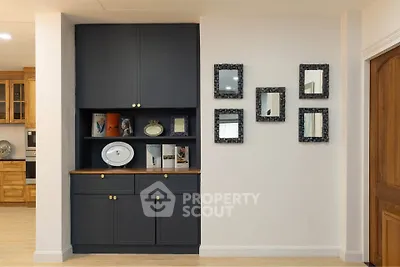 Charming interior with elegant built-in shelving and decorative mirrors, perfect for stylish living.