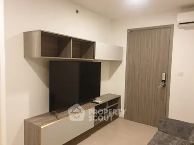 Modern living room with sleek TV unit and stylish door, perfect for contemporary living.