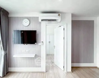 Modern minimalist living room with wall-mounted TV and air conditioning