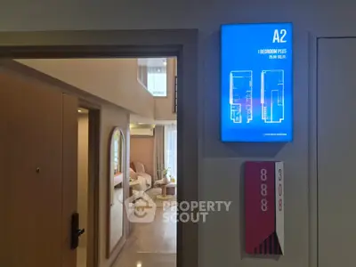 Modern apartment entrance with floor plan display and stylish interior view.