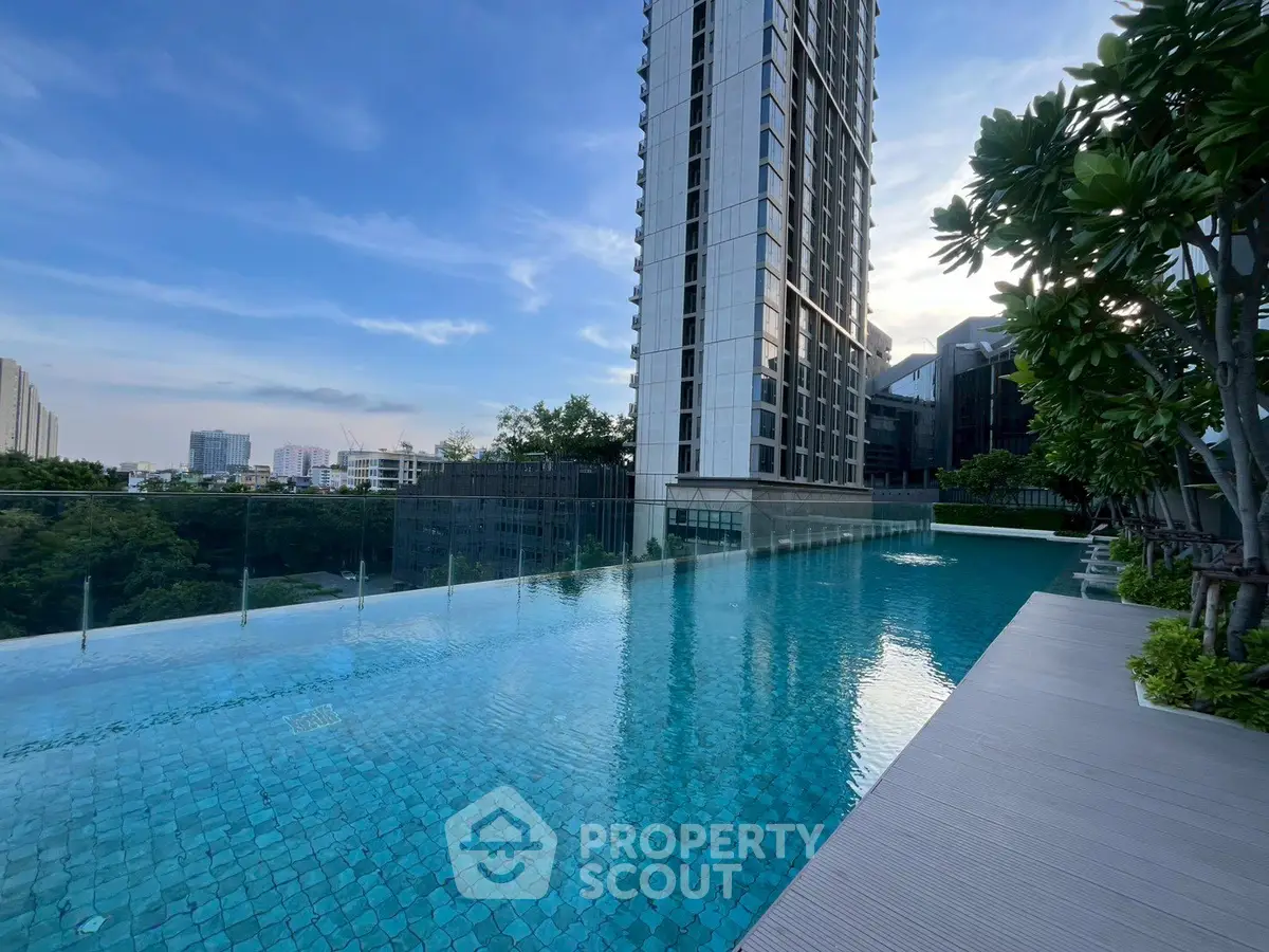Luxurious high-rise building with stunning rooftop infinity pool and city views.