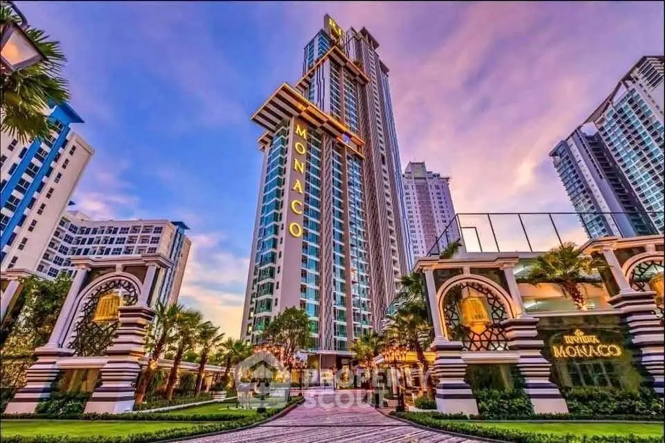 Luxurious high-rise building with stunning architecture and lush landscaping at sunset.