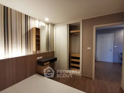 Modern bedroom with stylish wallpaper and built-in wardrobe